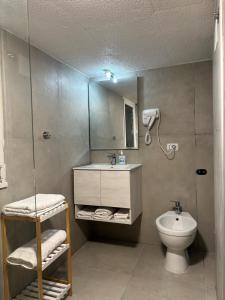 a bathroom with a toilet and a sink and a mirror at B&B IL GIRASOLE in Maddaloni +33 photos