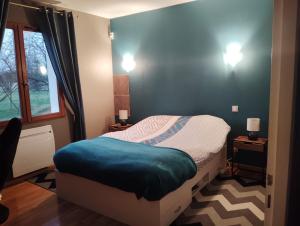 a small bedroom with a bed and a window at Villa évasion in Ambillou