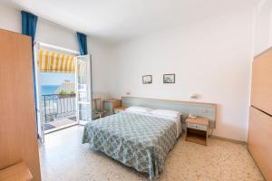 a bedroom with a bed and a view of the ocean at Stella Hotel in Sirolo