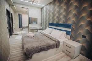 a small bedroom with a bed and a mirror at Sabah Bayil Residence Family Apart in Baku +49 photos