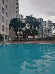 a large blue swimming pool in the middle of a city at Toscana Suite 3009 in Las Margaritas