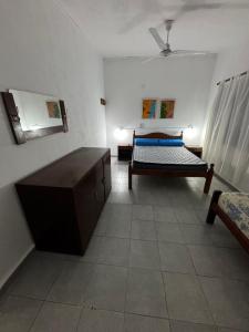a room with two beds and a table in it at Casa en Paso II in Paso de la Patria
