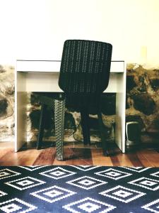 a black chair sitting next to a white desk at The Tree House in Cusco