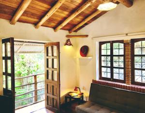 a living room with a couch and a window at The Tree House in Cusco +16 photos