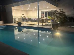 a house with a swimming pool in front of a house at That White House in Warrnambool
