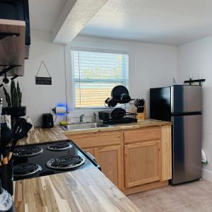 a kitchen with a stove and a stainless steel refrigerator at Private, cozy, beach guest-suite C in Venice +16 photos