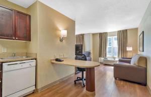 a hotel room with a table and a kitchen and a living room at Extended Stay America - Atlanta - Marietta - Interstate N. Pkwy in Atlanta