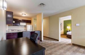 a kitchen and living room with a table and chairs at Extended Stay America Suites - Houston - Med Ctr - NRG Park - Braeswood Blvd in Houston