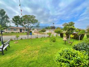 a park with a bench and a kite in the grass at Cozy Beautiful Private Home in Prime Location in Glendora