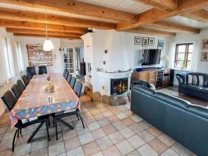 a living room with a table and a fireplace at 4 star holiday home in Bagenkop in Bagenkop