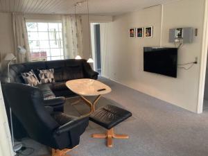 a living room with a couch and a table at 6 person holiday home in Ansager in Ansager