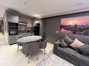 a living room with a couch and a table at Studio on the Nile with full equipment in Al Ma‘şarah