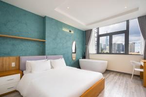 a bedroom with a bed and a desk and a window at Hoshi Apartment in Ho Chi Minh City