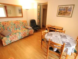 a living room with a couch and a table at Appartement centre Luchon, balcon sud, parking - FR-1-313-243 in Luchon