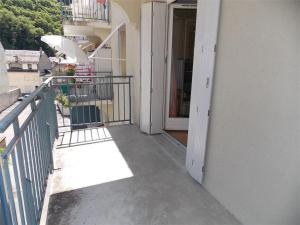 a balcony of a building with an open door at Appartement centre Luchon, balcon sud, parking - FR-1-313-243 in Luchon +3 photos