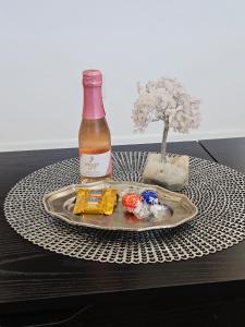 a tray with a bottle of wine and a miniature tree at Newly Renovated Modern Studio in Oviedo