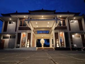a building with a statue in front of it at night at Nala's Home in Uluwatu