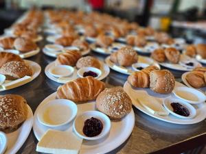 a table topped with plates of pastries and croissants at La Posada del Chagra HOST in Machachi
