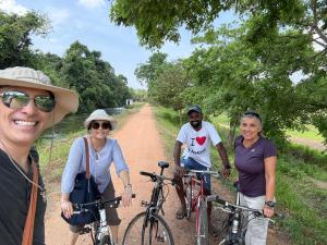 a group of people on a dirt road with bikes at Priya Homestay Kandalama in Dambulla