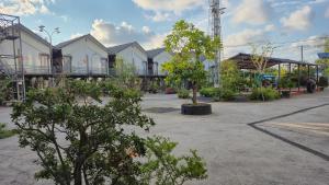 a group of buildings with trees in a parking lot at Mobile Home Ho Tram Pristine Beach in Thuận Biên