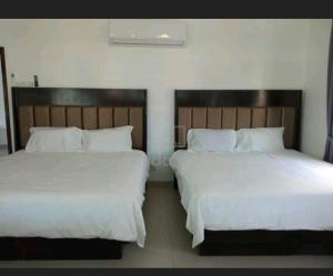 two beds sitting next to each other in a bedroom at EDS Senior Citizen Care Centre in Cheras