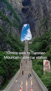a group of people walking on a mountain cave car station at Heavens Gate homestay free pick up service from train station and airport in Zhangjiajie