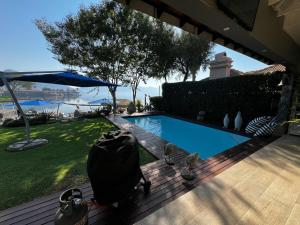 a swimming pool in the backyard of a house at Pecanwood Exclusive Luxury Villa Hartbeesport Dam in Hartbeespoort