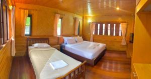 Postel nebo postele na pokoji v ubytování Baan Soontree Resort