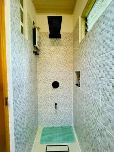 a shower with a green mat in a bathroom at Bohol Seafront Villa Pasan Cove a resort homestay in Guindulman