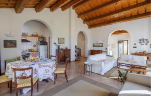 a living room with a table and a couch at Amazing Home In Montemarciano With Wifi in Alta Marina