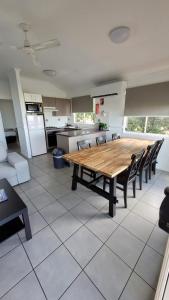 a large kitchen with a wooden table and chairs at BIG4 Lake Maraboon Holiday Village in Gindie