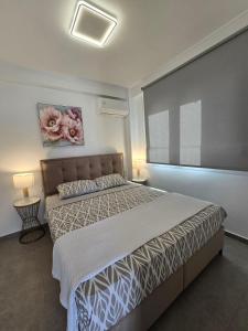 a bedroom with a bed and a large window at Anastasia in Ofrínion
