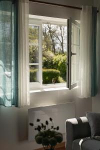 a living room with a window and a couch at Gite de l'étang in La Puisaye
