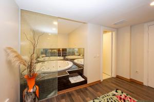 a bathroom with a large mirror and a tub at The Marions Suite - Central Comfortable Stay in Taksim in Istanbul