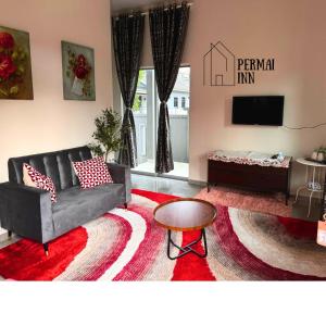a living room with a couch and a table at Roomstay Homestay Permai Inn Pekan in Pekan