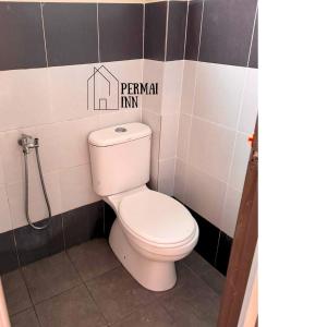 a bathroom with a toilet with a sign on the wall at Roomstay Homestay Permai Inn Pekan in Pekan +35 photos