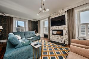 a living room with a blue couch and a fireplace at Bank House, Bushmills in Bushmills