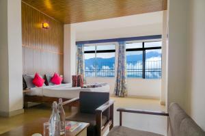 a hotel room with a bed and a window at Blissful Stay, 2-min drive from MG Market in Gangtok