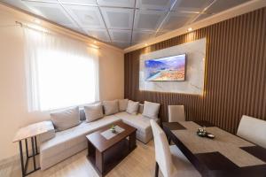 a living room with a couch and a table at Azzuro apartments Budva in Budva