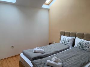 ein Schlafzimmer mit zwei Betten mit Handtüchern darauf in der Unterkunft Center Apartments The Quiet Luxury 8 in Plowdiw + 3 Fotos