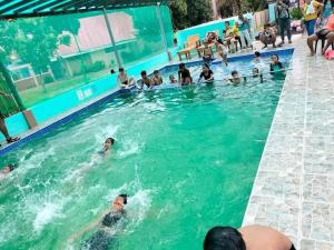 a group of people swimming in a swimming pool at La Jose Beach Resort in Pagudpud