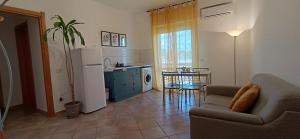 a living room with a couch and a kitchen at TOP Apartment in Catanzaro