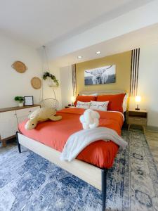 a bedroom with a red bed with a stuffed animal on it at RodeoBohoPOOLJacuzziNRGwalk TMC Ps4Wii MDAnderson in Houston +66 photos
