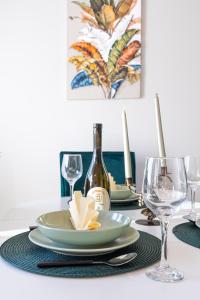 a table with a plate and wine glasses on it at Lana Lux 18 in Subotica