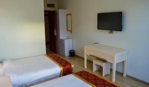 TV a/nebo společenská místnost v ubytování Wuduria Hotel