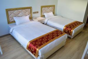 Postel nebo postele na pokoji v ubytování Wuduria Hotel