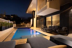 a house with a swimming pool at night at Villa Vibes Eilat - Villa Astoria in Eilat