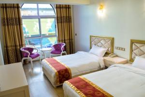 Postel nebo postele na pokoji v ubytování Wuduria Hotel