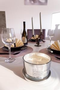 a table with a candle and wine glasses on it at Lana Lux 19 in Subotica