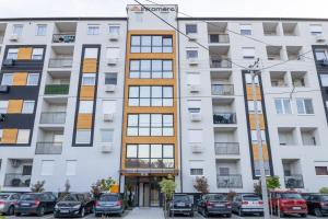 an apartment building with cars parked in front of it at Lana Lux 19 in Subotica